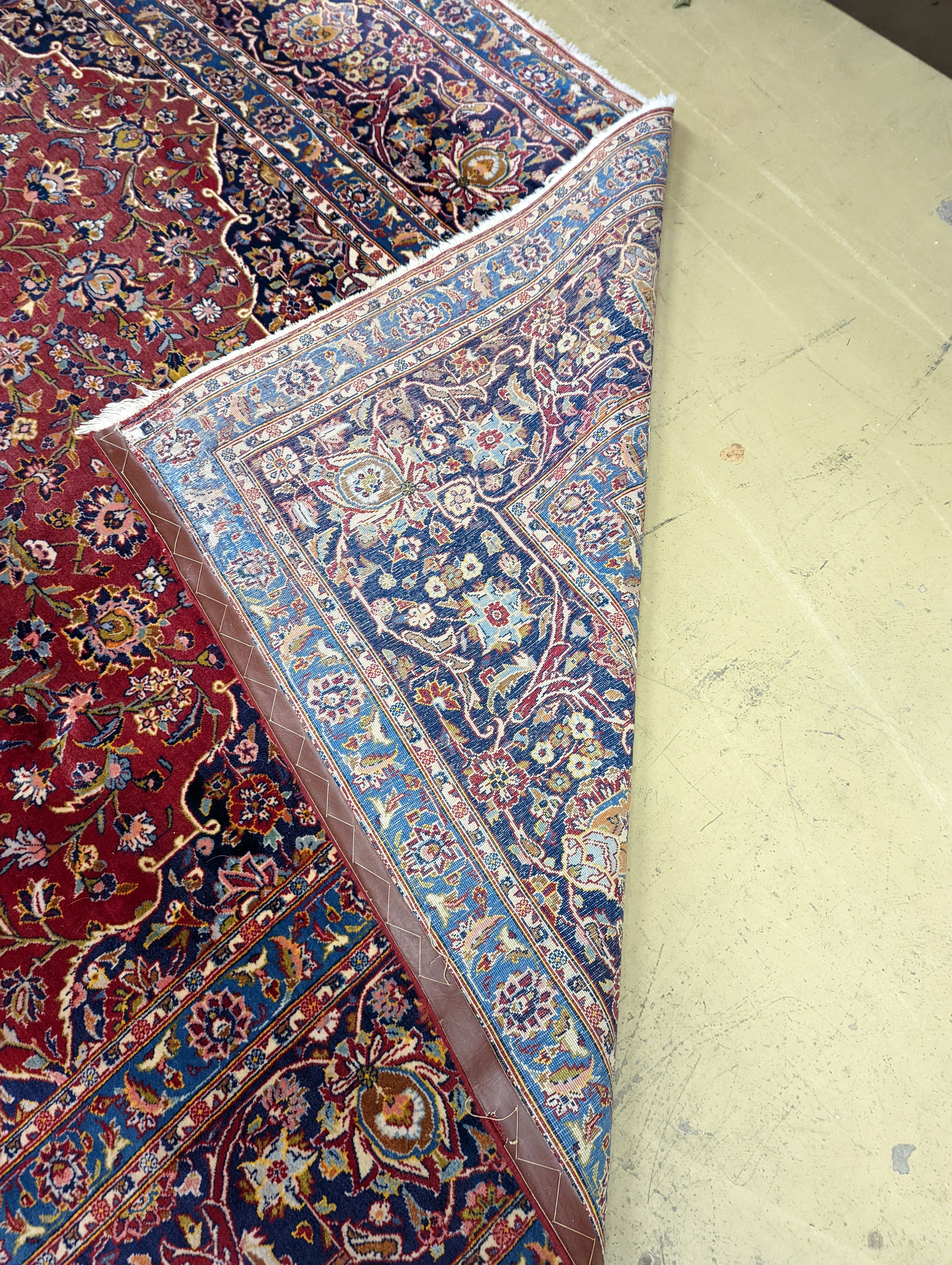 A large Tabriz red ground floral carpet, 540 x 350cm